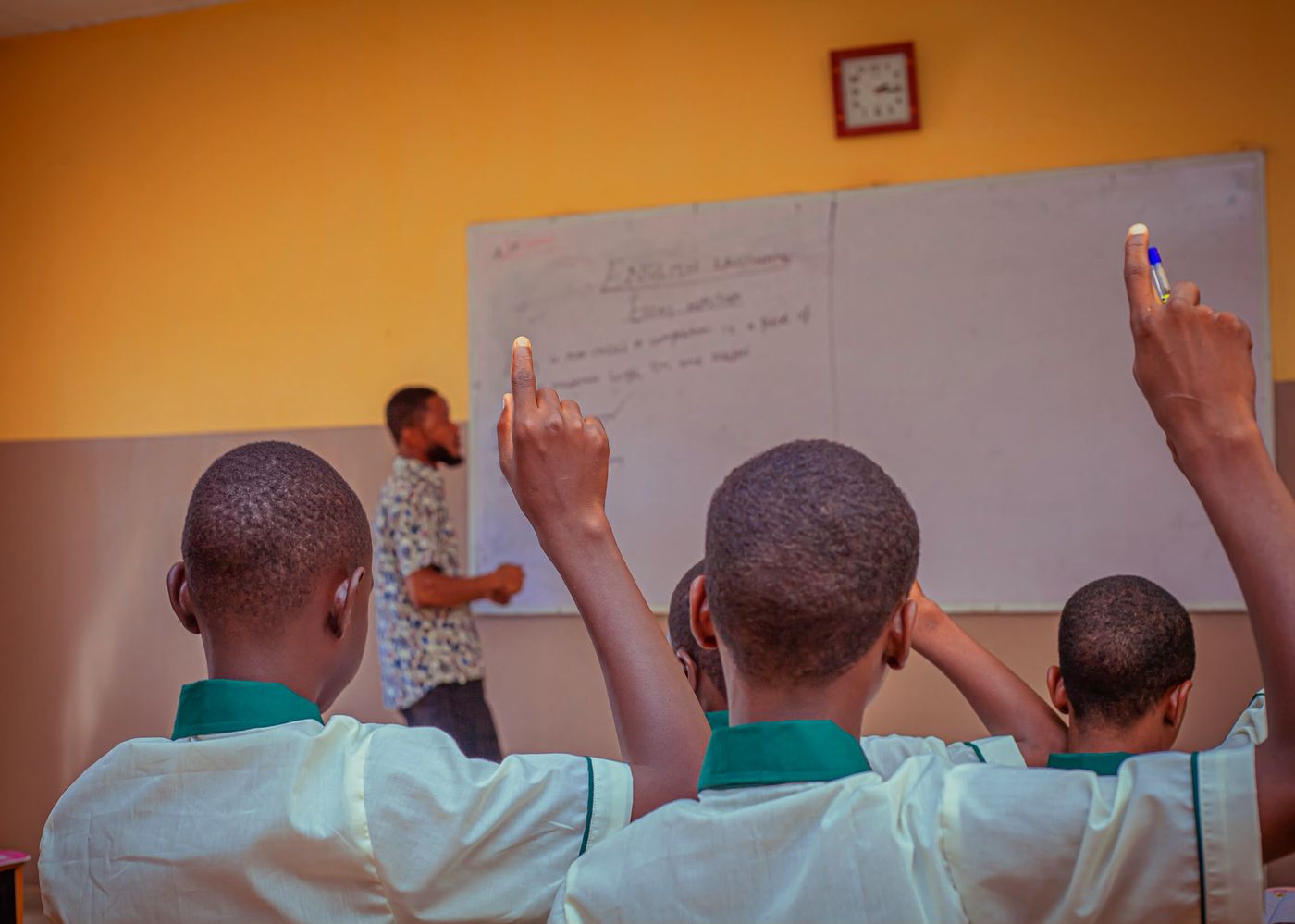 Pupils raising their hands in class
